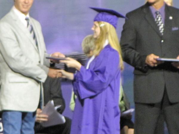 Accepting the Diploma! WOOT! no more hellsville at 6am.