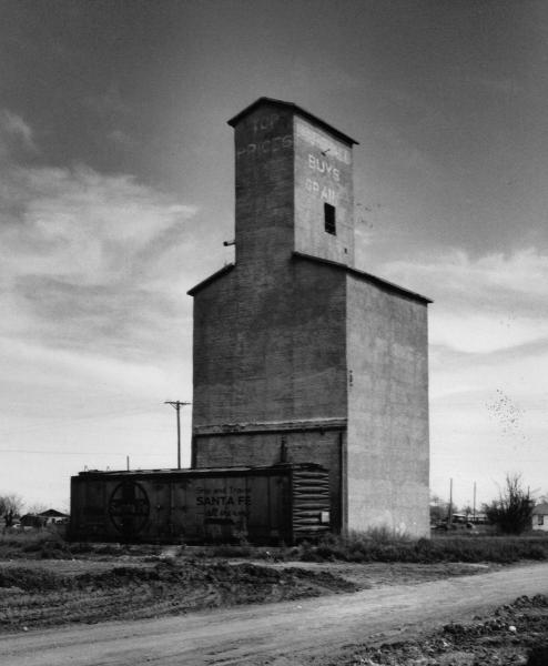 "The End of the Line in Matador"   A common scene throughout west Texas. Abandoned grain silos or elevators dot the landscape, serving as monuments to the past and the simplified methods of agrarian commerce.
B&W film photograph, early 1990's