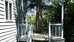 wraparound deck -- isn't this cool? My dad didn't have the heart to cut down this mighty old hemlock, so, we decked around it! Our house on the lake....