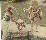 My cousin Jennifer and I playing with my tricycle