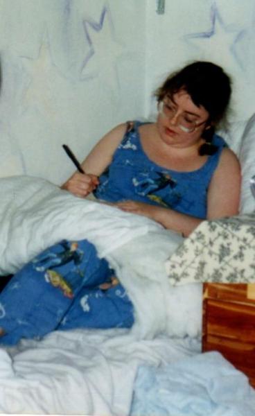Writing in my diary.  I made my bed in my closet.  The closet and ceiling were painted blue and had stars and a moon that were painted with glow-in-the-dark paint.  When I turned off my light at night, the stars came out.