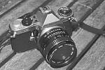 The "old" Pentax ME Super 35mm SLR film camera . Photo taken with my new Pentax K-7 Digital SLR using old manual lens w/ physical "red" filter and...