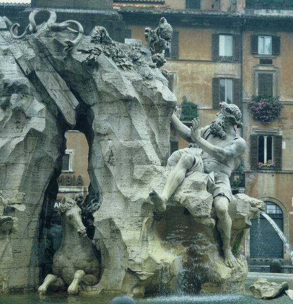 Gian Lorenzo Bernini�s   �Fountain of the Four Rivers� in the center of Piazza Navona Rome - 1652. The figure shown here represents the Danube with right arm reaching up to touch the Papal Coat of Arms.
Photo taken in 1988